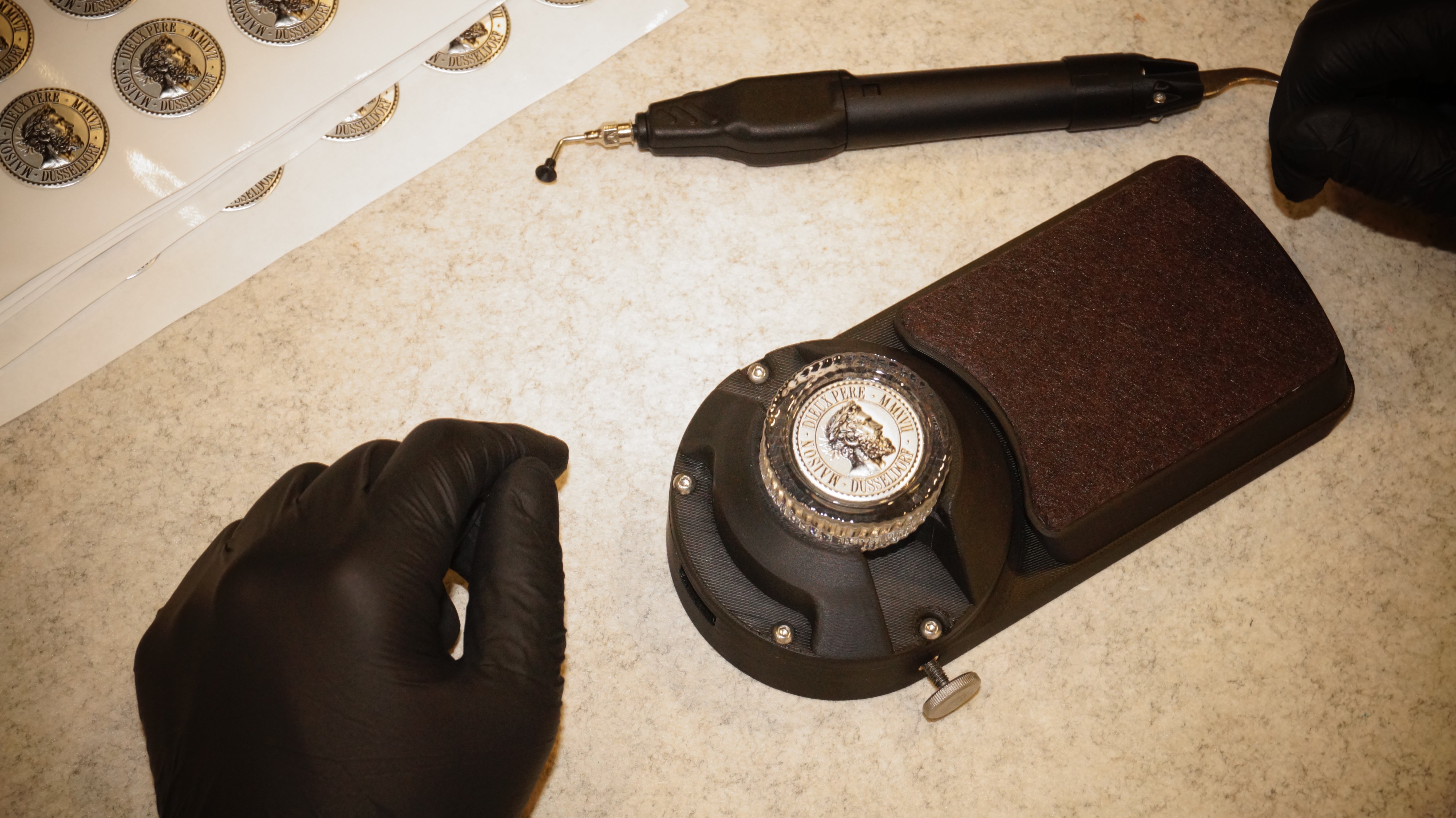 Maison Dieux Père medallion and workshop tools during the craft process in our atelier.