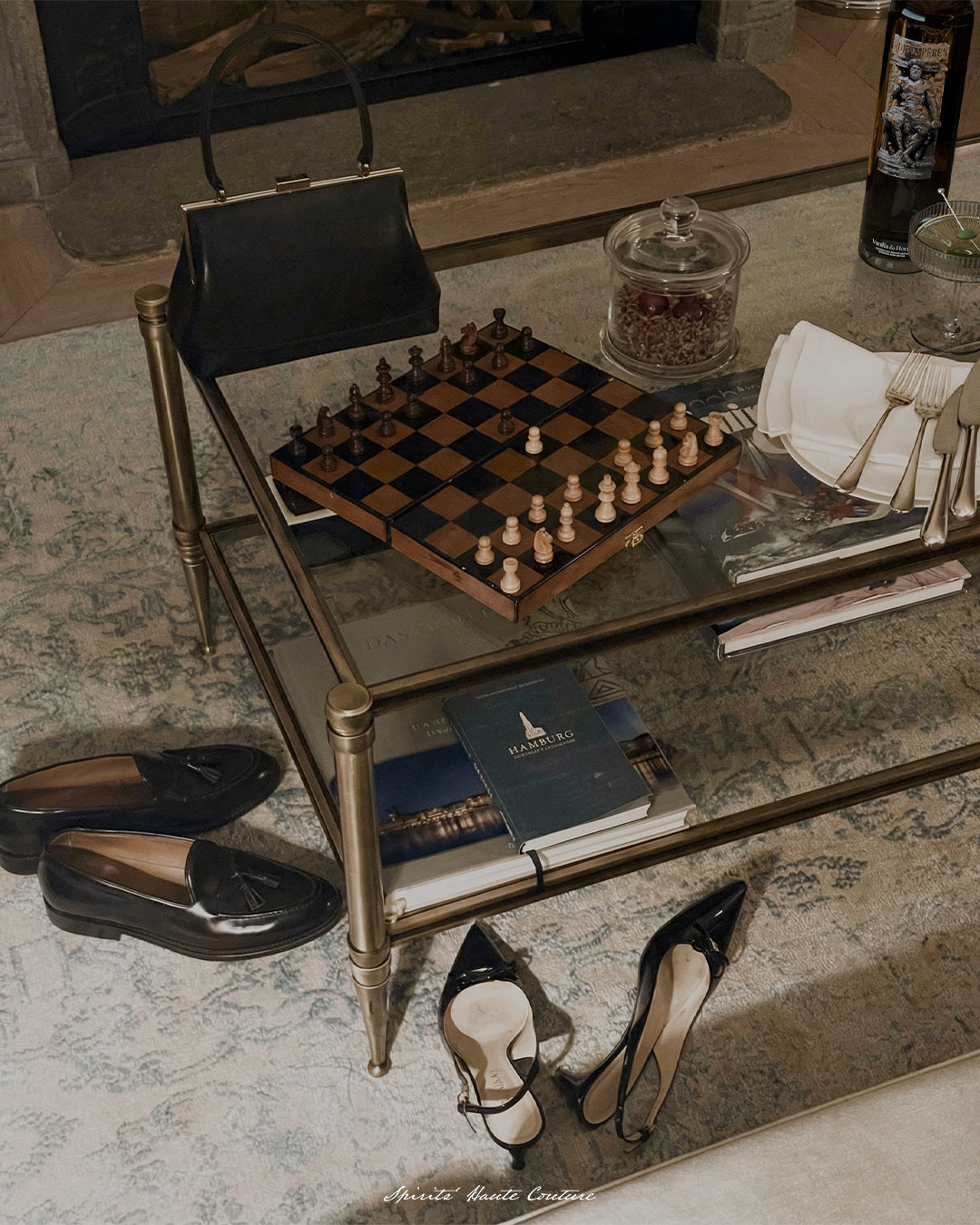 Maison Dieux Père bottle on a private evening table with chessboard and glassware in Hamburg.