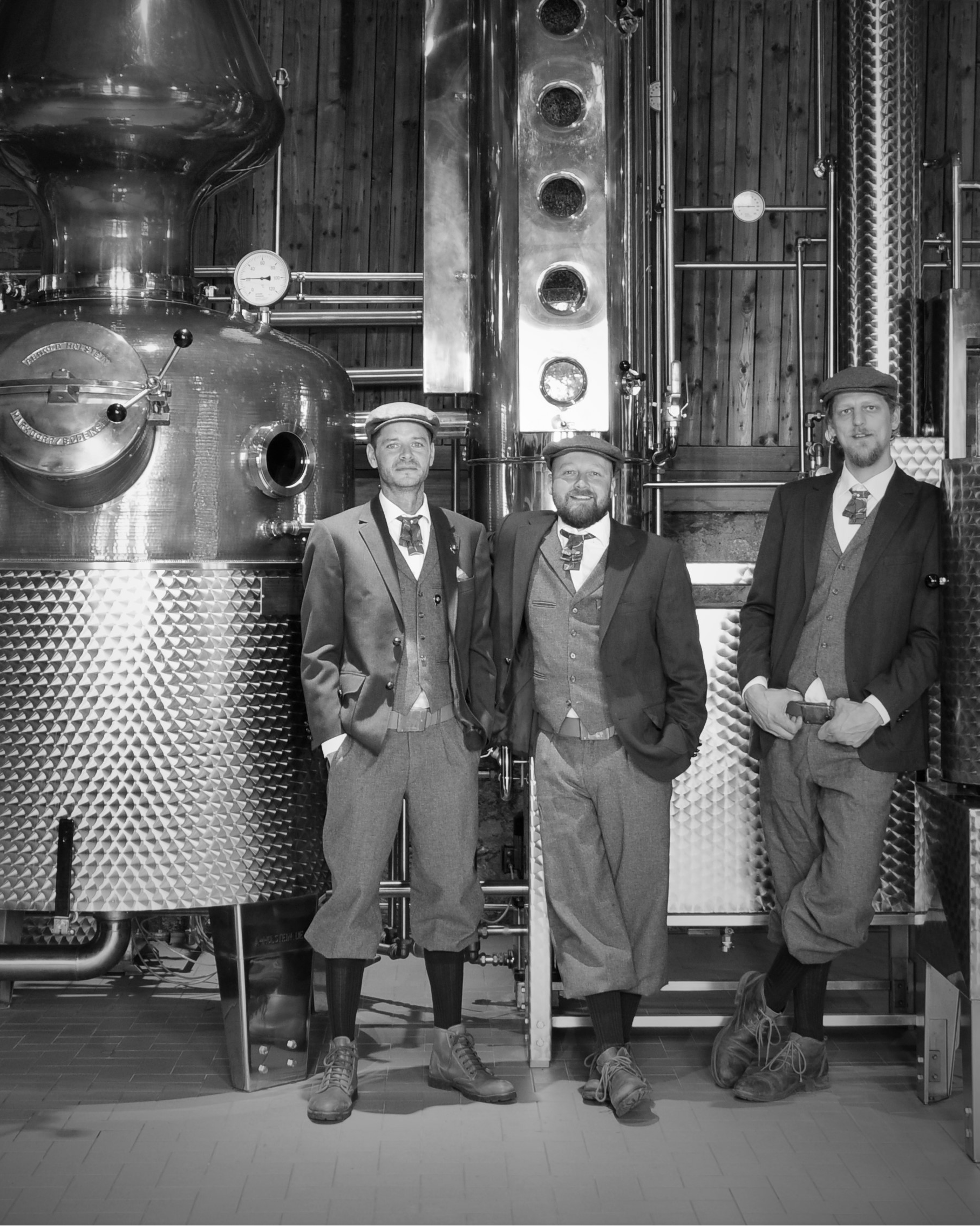 Maison Dieux Père distillery team posing in the Sauerland facility with copper stills.