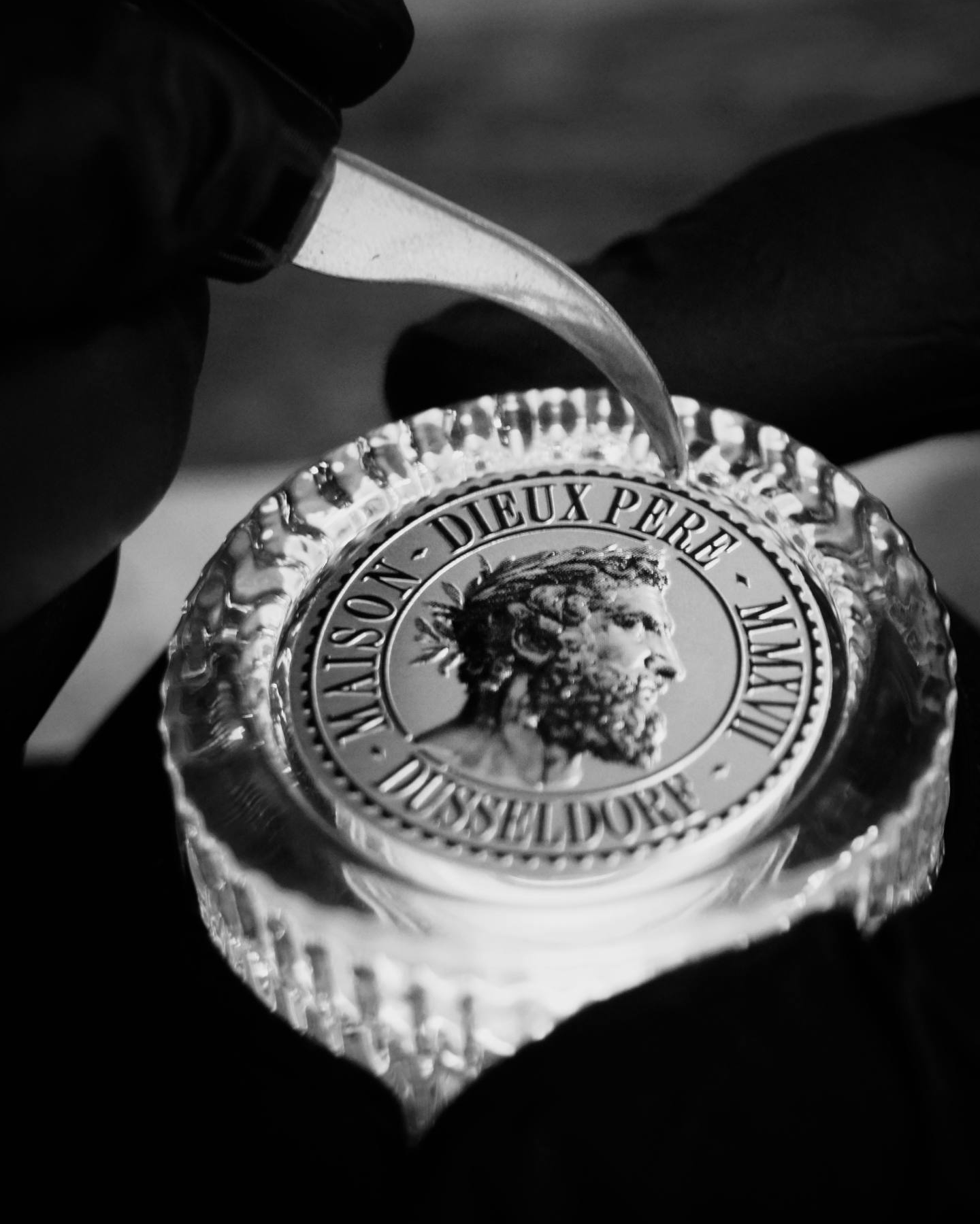 Detail of the Maison Dieux Père glass stopper and embossed medallion on the vodka macérat bottle.
