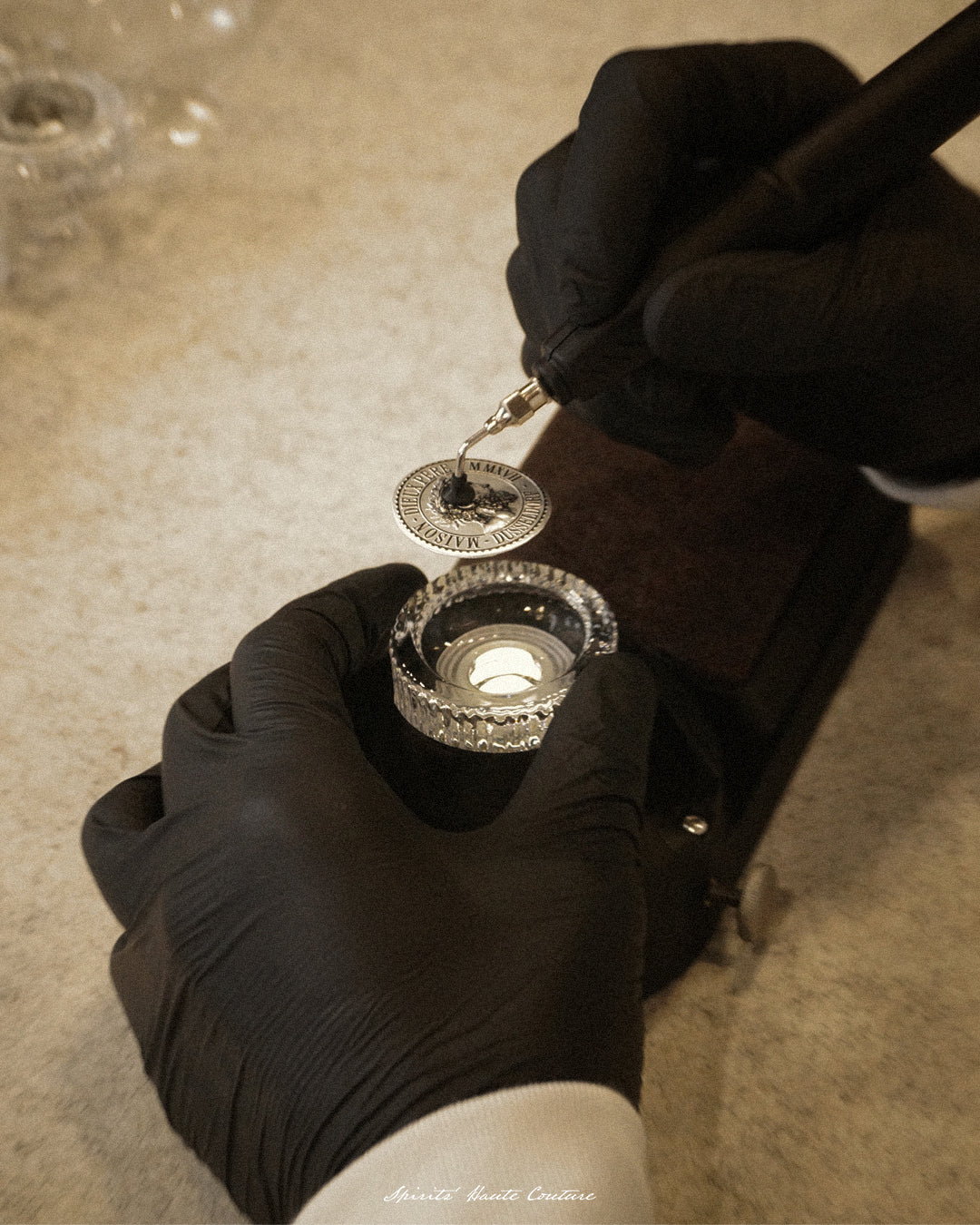Maison Dieux Père glass stopper being prepared and sealed by hand.